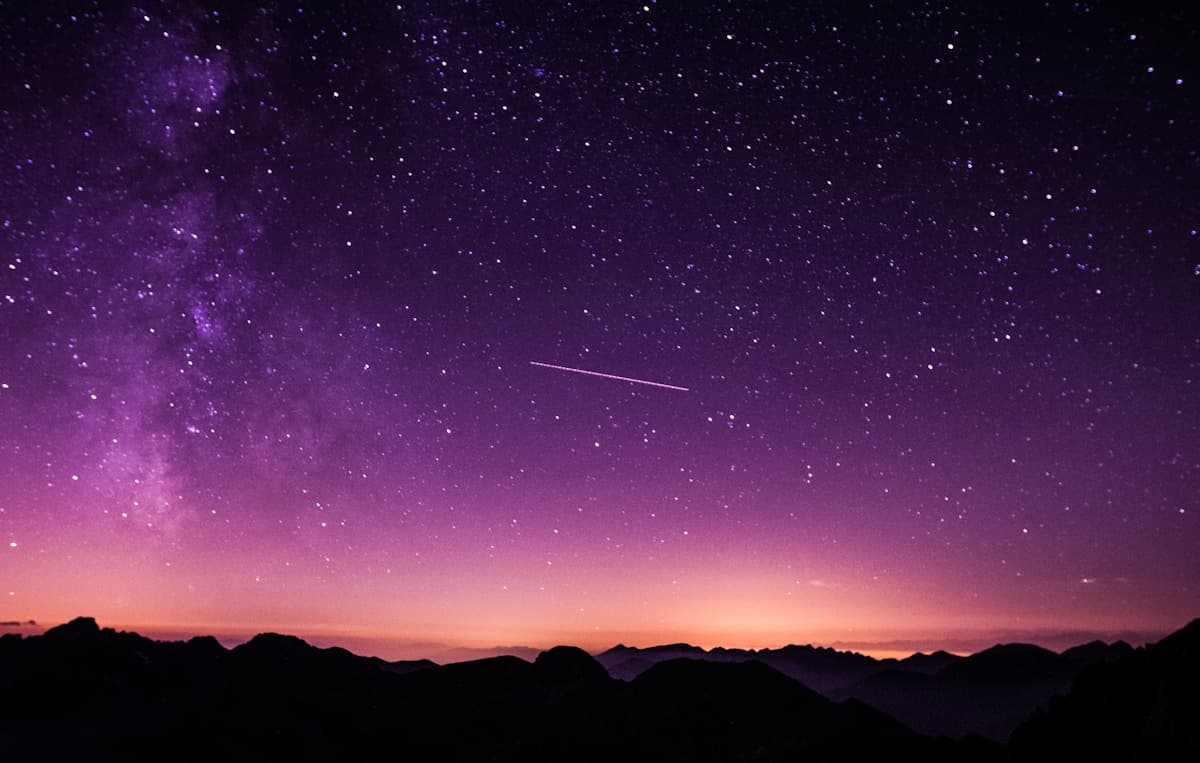 Starry night sky over mountains — birth chart timing and dasha readings