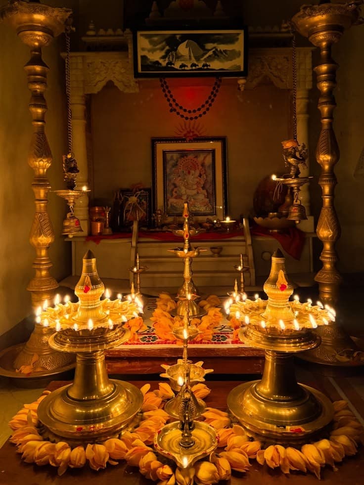 Puja altar with Ganesha and lit brass diyas — wealth, finance, and prosperity themes in Jyotish