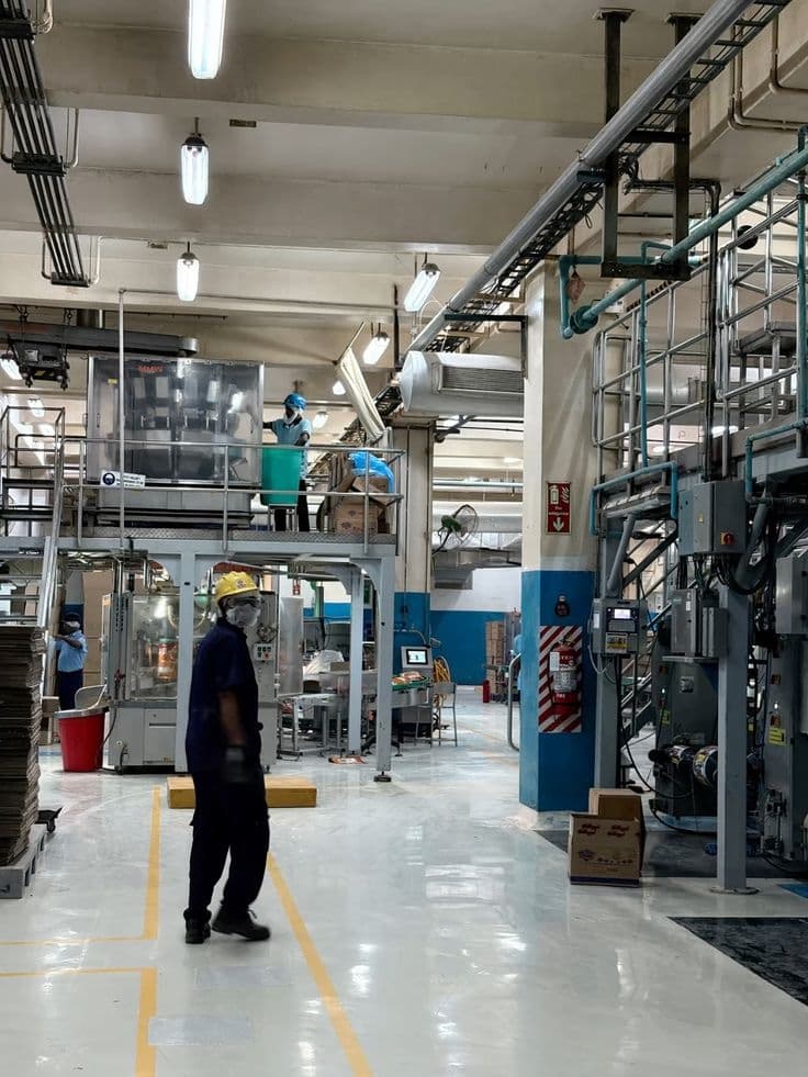 Bright factory floor with production zones and machinery — industrial Vastu for layout and workflow